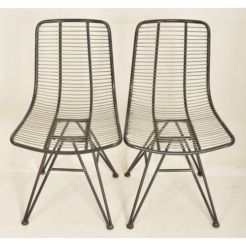 327 - A set of four modern designer metal and wire worked dining chairs / cafe chairs. Each having tubular... 