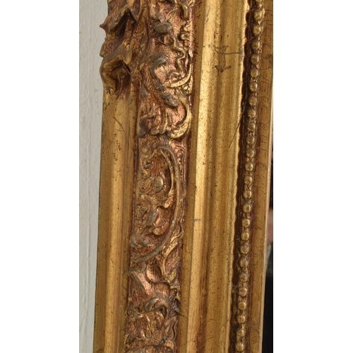 377 - A large 20th century gilt resin hanging wall mirror in the Rococo style. The mirror having a floral ... 