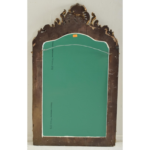 377 - A large 20th century gilt resin hanging wall mirror in the Rococo style. The mirror having a floral ... 