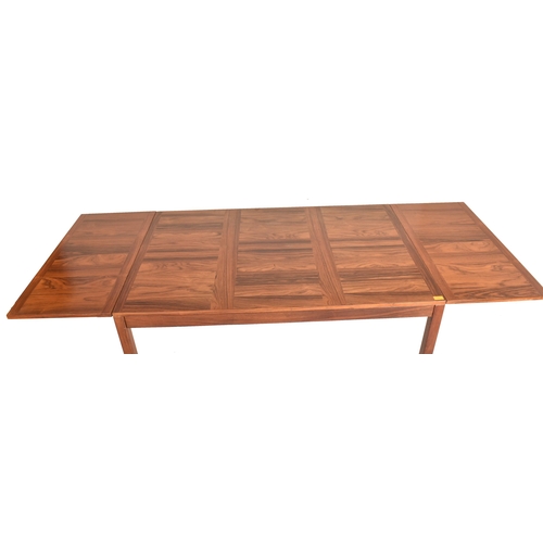 556 - WITHDRAWN - Vejle Stole - a vintage mid century Danish design rosewood extending dining table. The t... 