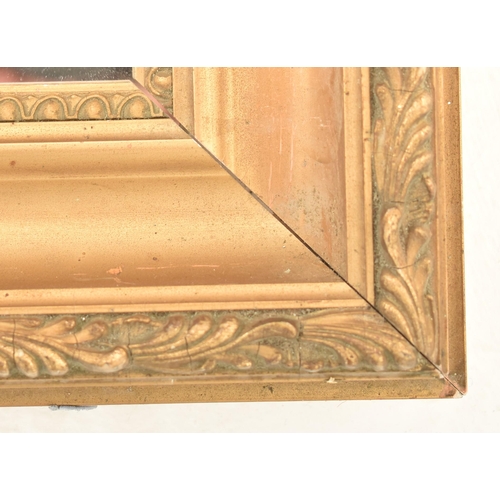 571 - An early 20th century gilt wood and gesso framed hanging mirror. The mirror of rectangular form with... 