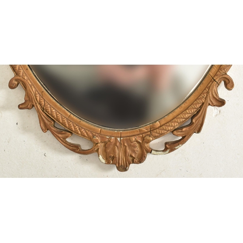 589 - A vintage mid century gilt framed hanging mirror. The mirror of oval form having acanthus pierced mo... 