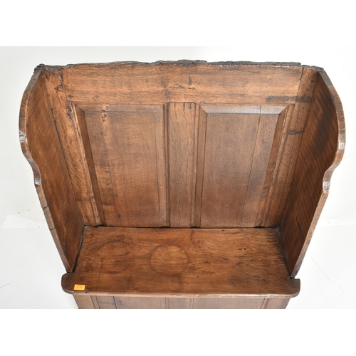 226B - A 19th century elm & oak wood reclaimed small settle bench. The settle having a high panelled back w... 