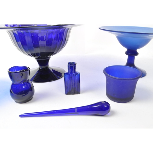 101 - A collection of 20th century Bristol blue studio art glass. The collection to include jugs, vases, b... 