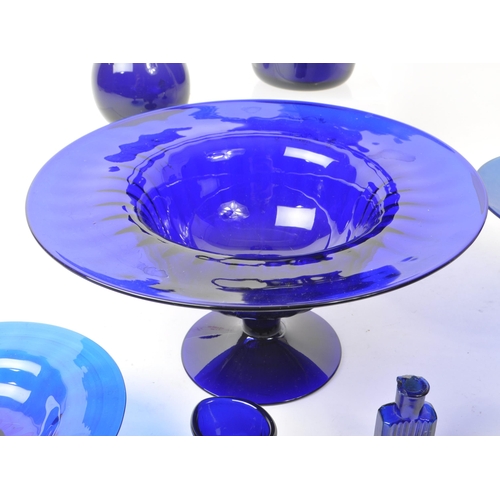 101 - A collection of 20th century Bristol blue studio art glass. The collection to include jugs, vases, b... 