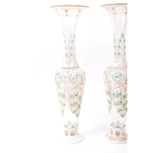 113 - A pair of 19th century Czech Bohemian glass vases. Each vase raised on a rounded base, with flared t... 