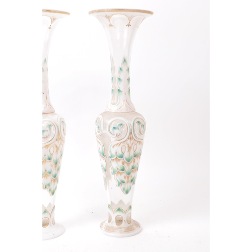 113 - A pair of 19th century Czech Bohemian glass vases. Each vase raised on a rounded base, with flared t... 