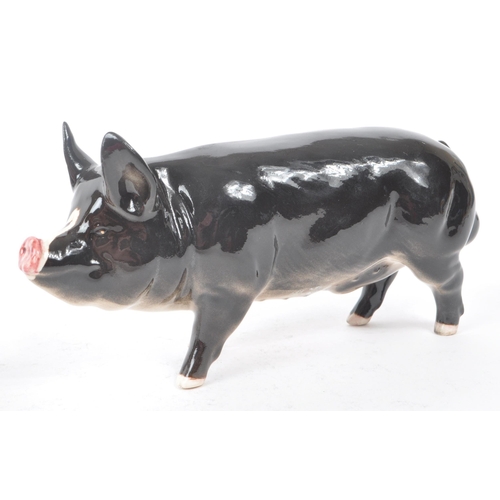 12 - Beswick - Royal Doulton - A collection of three 20th century porcelain pig figurines, comprising of,... 