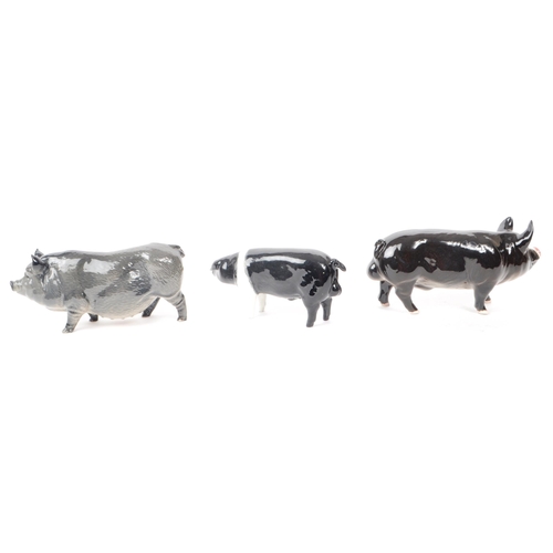 12 - Beswick - Royal Doulton - A collection of three 20th century porcelain pig figurines, comprising of,... 