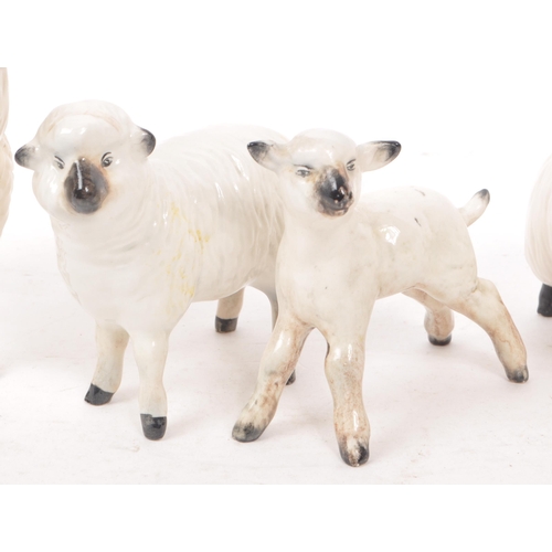 13 - Beswick - A collection of five 20th century sheep figurines, comprising of a ram, two sheep with hor... 