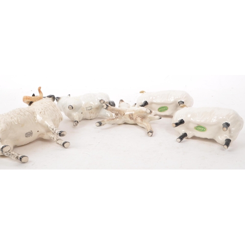 13 - Beswick - A collection of five 20th century sheep figurines, comprising of a ram, two sheep with hor... 