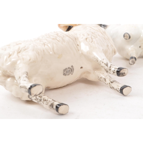 13 - Beswick - A collection of five 20th century sheep figurines, comprising of a ram, two sheep with hor... 