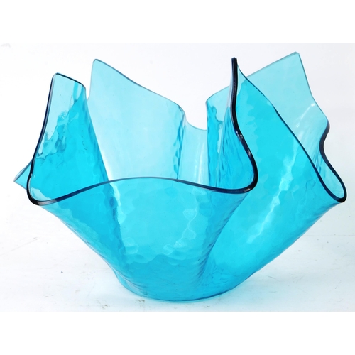 136 - Two pieces of vintage mid-20th-century glass table pieces, comprised of a green vase, and a blue han... 