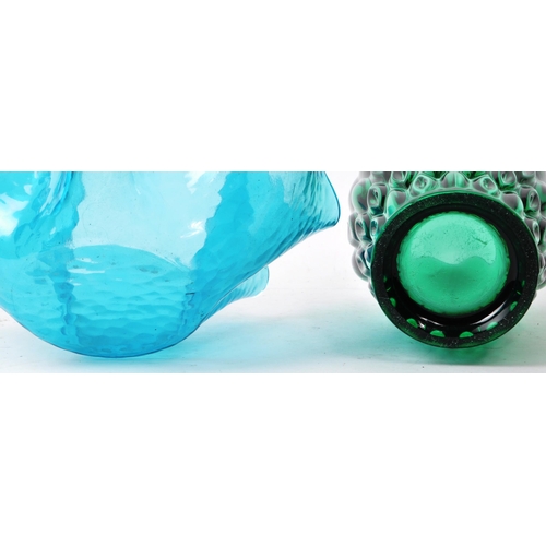 136 - Two pieces of vintage mid-20th-century glass table pieces, comprised of a green vase, and a blue han... 