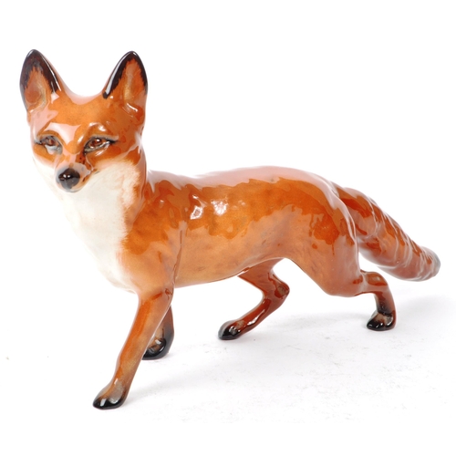 14 - Beswick - Three 20th century porcelain fox figurines, comprising of a walking adult fox, with two si... 