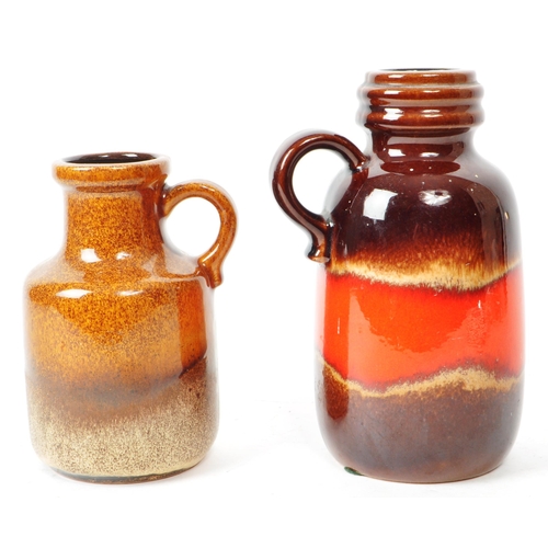 141 - A pair of mid-century West German pottery vases / jugs, decorated with a brown and red glaze. Both f... 