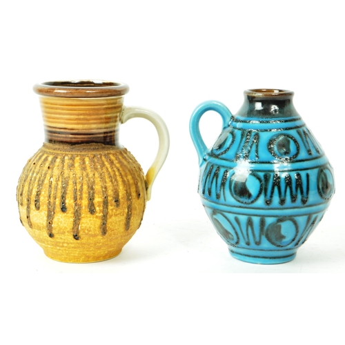 142 - A pair of mid-century Austrian pottery vase / jug pieces, both with a round, bulbous body, and a sin... 