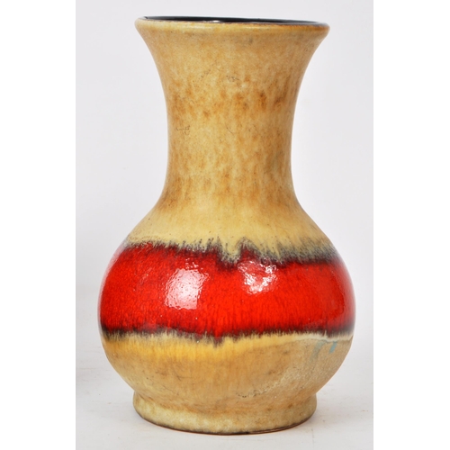 144 - A collection of three mid-century West German pottery vases, in various shapes such as a bullet vase... 