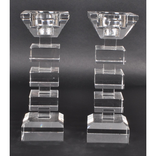 149 - A pair of late 20th-century art deco-style crystal glass candle stick holders. Featuring squared seg... 