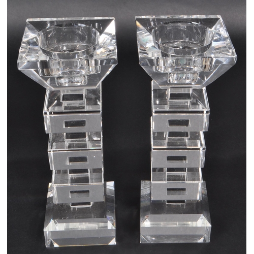 149 - A pair of late 20th-century art deco-style crystal glass candle stick holders. Featuring squared seg... 