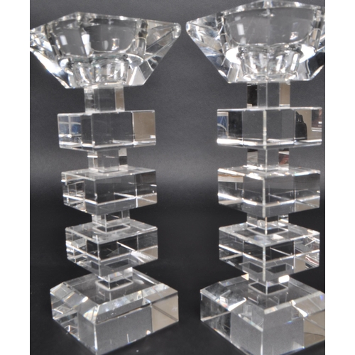 149 - A pair of late 20th-century art deco-style crystal glass candle stick holders. Featuring squared seg... 