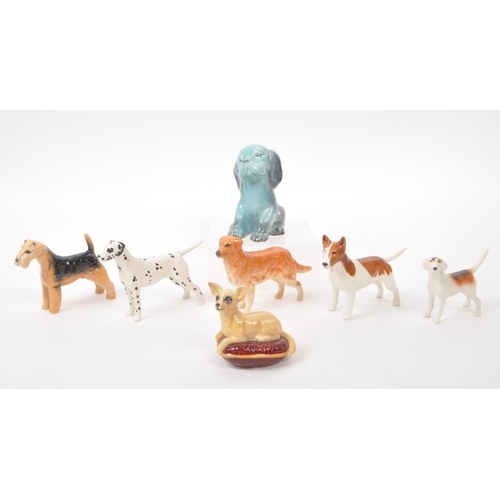 15 - Beswick - A collection of seven 20th century porcelain dog figurines, including, a Dalmatian, a Chih... 