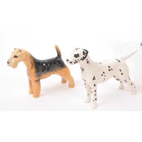 15 - Beswick - A collection of seven 20th century porcelain dog figurines, including, a Dalmatian, a Chih... 