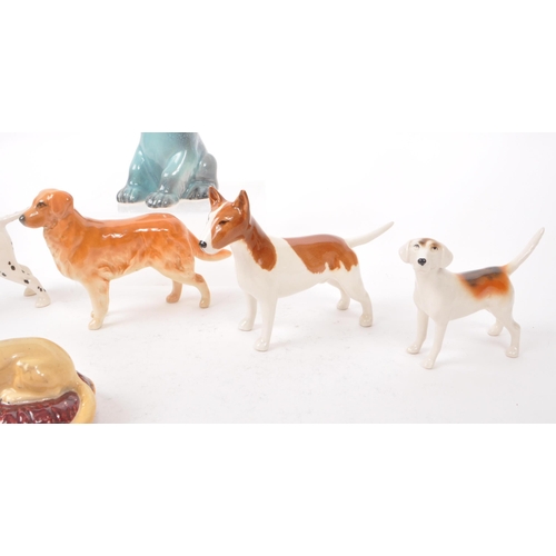 15 - Beswick - A collection of seven 20th century porcelain dog figurines, including, a Dalmatian, a Chih... 