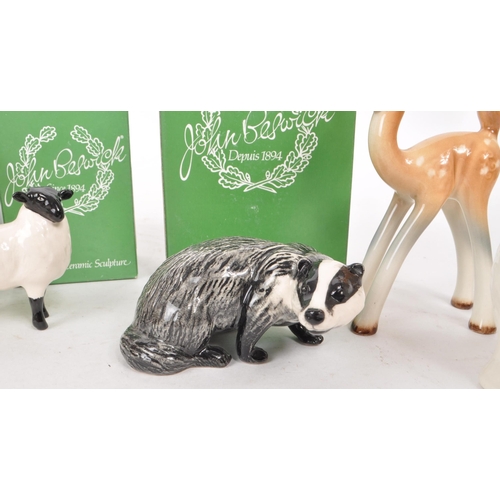 16 - Beswick - A collection of eight 20th century porcelain figurines, comprising a boxed badger figure, ... 