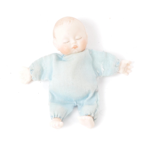 166 - A 20th century miniature bisque baby doll, stamped behind the head 'JSD', featuring a blue clothed b... 