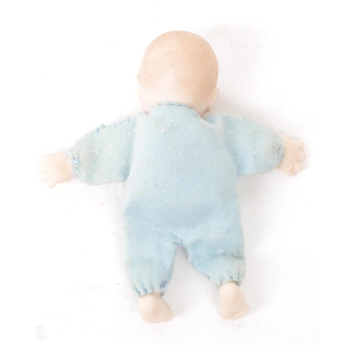 166 - A 20th century miniature bisque baby doll, stamped behind the head 'JSD', featuring a blue clothed b... 