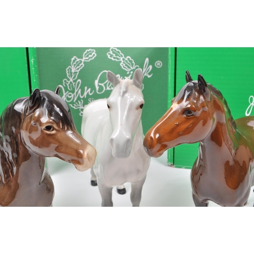 17 - Beswick - A collection of three mid century porcelain horse figurines, comprising of an Exmoor Horse... 