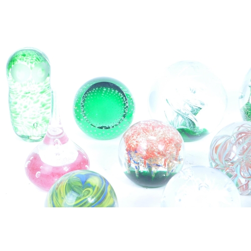 180 - A collection of vintage 20th century glass paperweights and other glassware. Mostly green floral exa... 