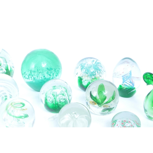 180 - A collection of vintage 20th century glass paperweights and other glassware. Mostly green floral exa... 