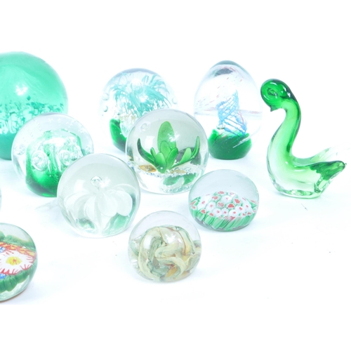 180 - A collection of vintage 20th century glass paperweights and other glassware. Mostly green floral exa... 