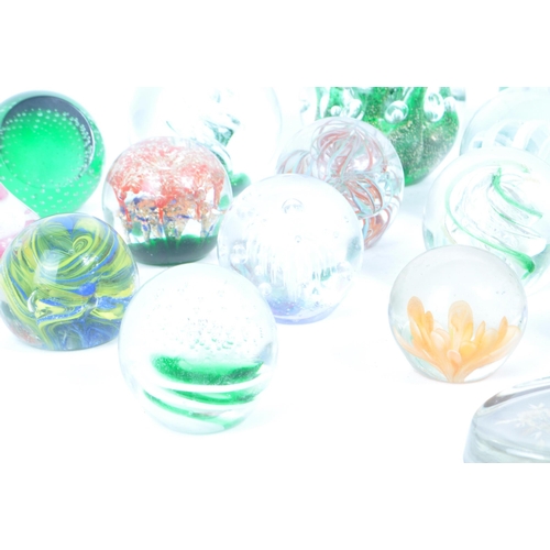 180 - A collection of vintage 20th century glass paperweights and other glassware. Mostly green floral exa... 