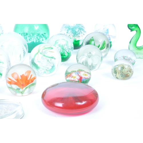 180 - A collection of vintage 20th century glass paperweights and other glassware. Mostly green floral exa... 