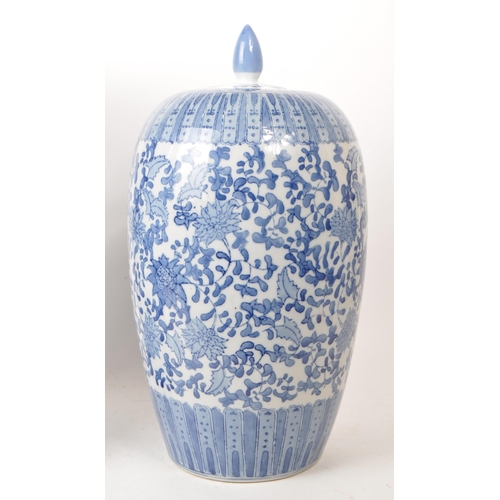 189 - 20th century Chinese large blue and white lidded vase and umbrella stand. Both featuring a floral / ... 