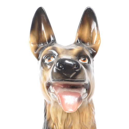 191 - A 20th century vintage porcelain German Shepherd figurine. The figurine being modelled panting in se... 