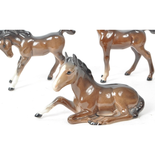 193 - Beswick - Five mid 20th century brown horse foal porcelain figurines. Beswick maker mark printed to ... 