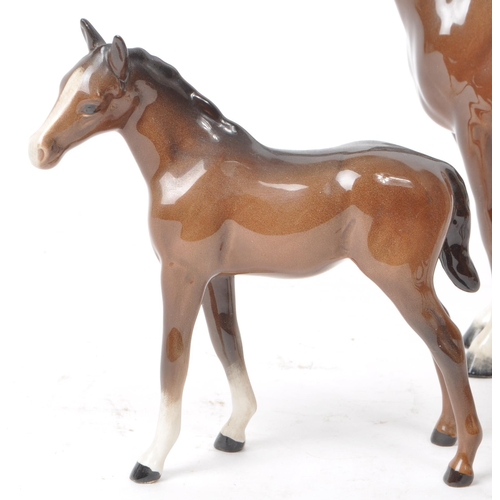 194 - Beswick - A 20th century porcelain Hackney Horse figurine and three foals, all with the maker mark p... 