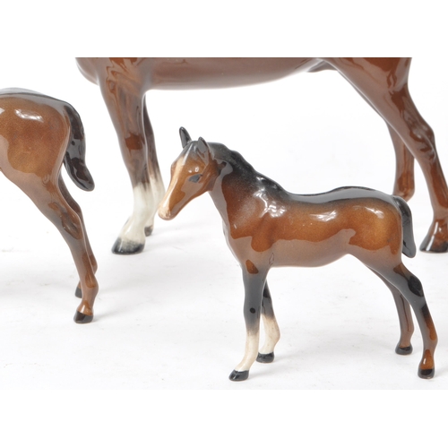 194 - Beswick - A 20th century porcelain Hackney Horse figurine and three foals, all with the maker mark p... 