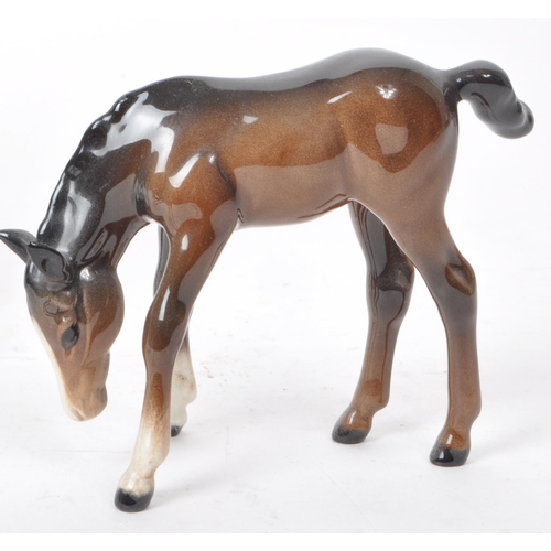 194 - Beswick - A 20th century porcelain Hackney Horse figurine and three foals, all with the maker mark p... 