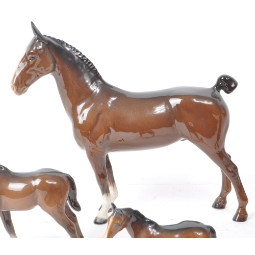 194 - Beswick - A 20th century porcelain Hackney Horse figurine and three foals, all with the maker mark p... 