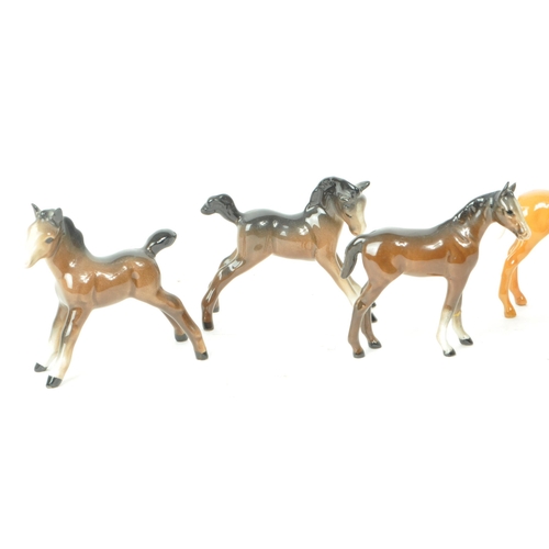 195 - Beswick - A collection of seven 20th century horse foals, comprised of four Palomino foals, standing... 