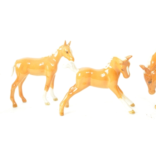 195 - Beswick - A collection of seven 20th century horse foals, comprised of four Palomino foals, standing... 