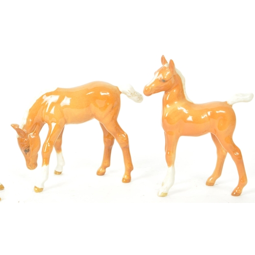 195 - Beswick - A collection of seven 20th century horse foals, comprised of four Palomino foals, standing... 