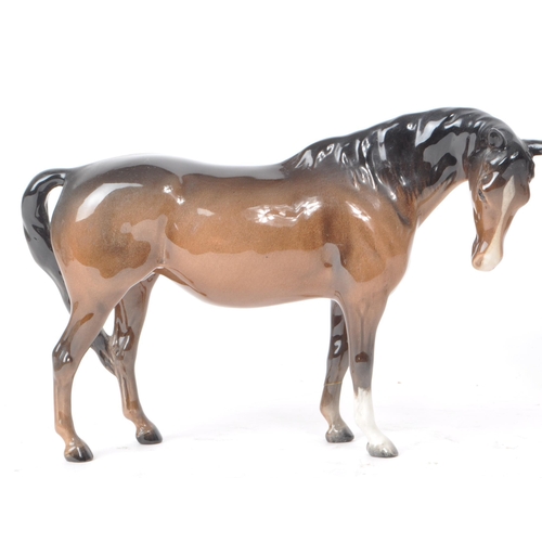 196 - Beswick - Three 20th century porcelain horse figurines, including a Dartmoor horse. All brown in col... 