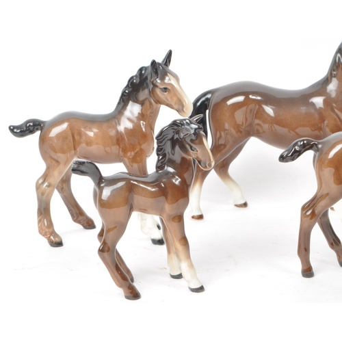 197 - Beswick - A collection of seven 20th century porcelain horse figurines, to include two shire foals, ... 