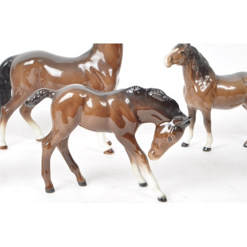 197 - Beswick - A collection of seven 20th century porcelain horse figurines, to include two shire foals, ... 